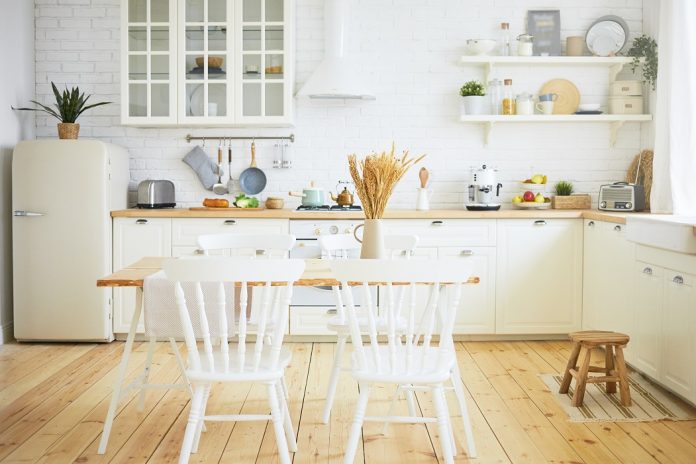 Stylish Scandinavian kitchen interior: chairs and table in foreg